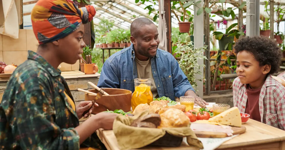 family-sitting-at-a-table-with-food-2023-11-27-04-55-38-utc1140x600