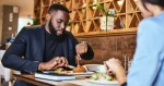 two-colleagues-having-lunch-in-company-s-restauran-2023-11-27-05-15-40-utc1140x600